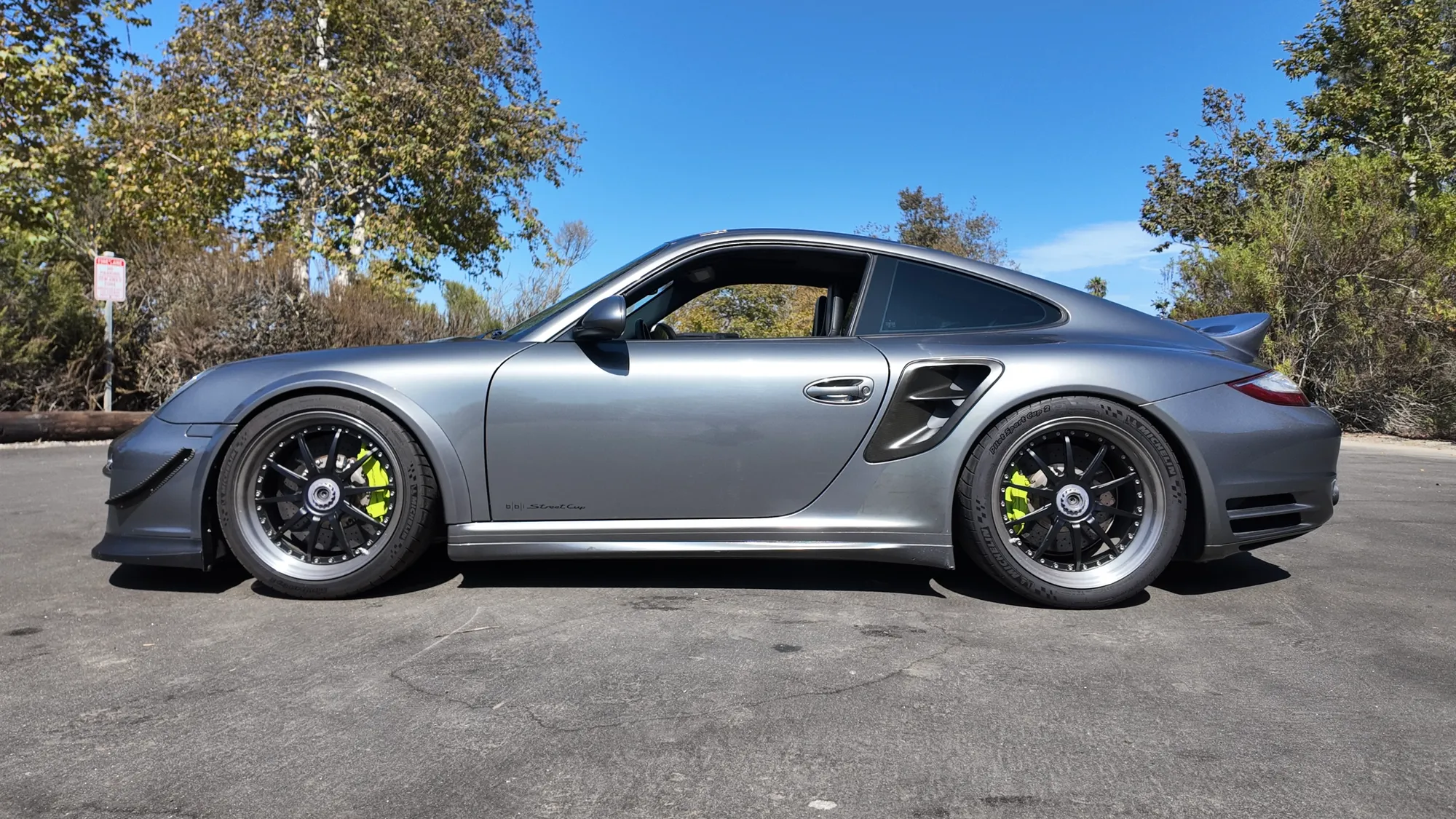 Side profile, showing the wide-body Turbo S proportions and centre-lock-style wheels